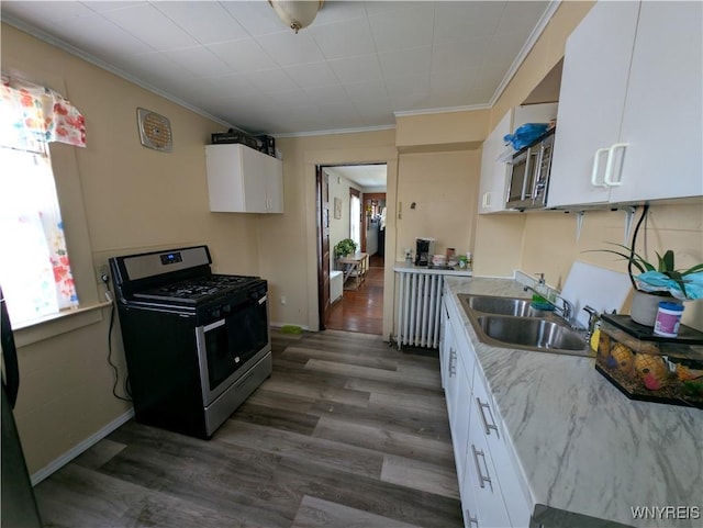 505 Canary St, Dunkirk-City, NY 14048 - kitchen with stainless steel gas range oven, a sink, ornamental molding, and dark wood finished floors