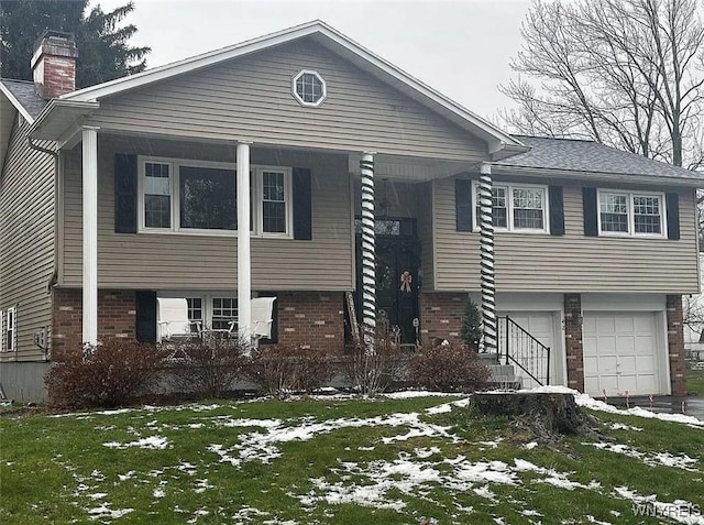 view of front of property featuring brick siding, an attached garage, and a chimney