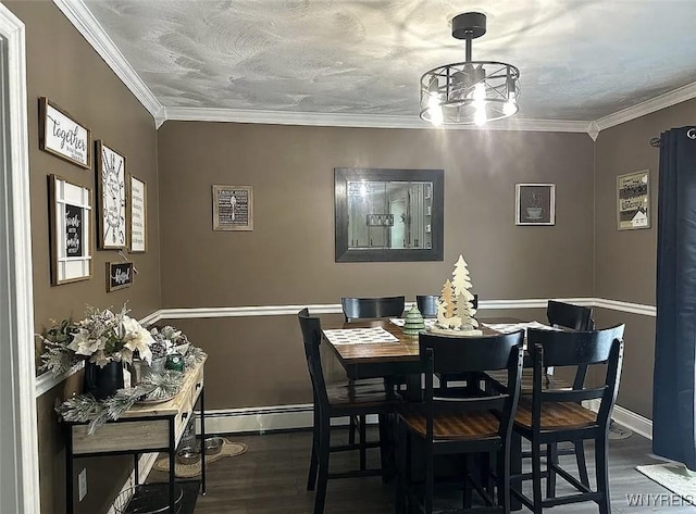 dining area featuring a textured ceiling, baseboards, crown molding, and dark wood finished floors