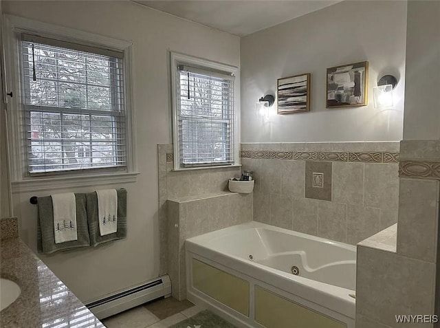 bathroom with tile patterned flooring, a jetted tub, and a baseboard heating unit