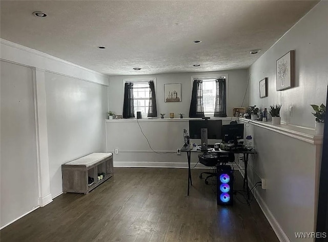 home office featuring a textured ceiling, wood finished floors, and baseboards