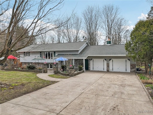 1465 Genesee St, Pembroke, NY 14036 - tri-level home featuring an attached garage, stone siding, roof with shingles, a front yard, and driveway