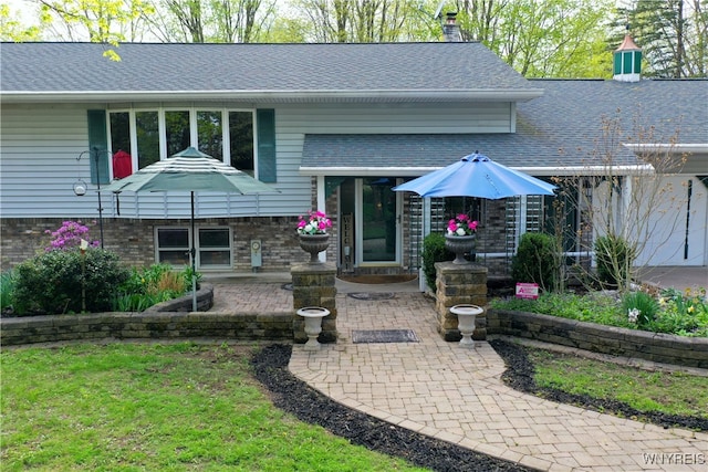 1465 Genesee St, Pembroke, NY 14036 - view of front facade with a shingled roof, a patio, and a chimney