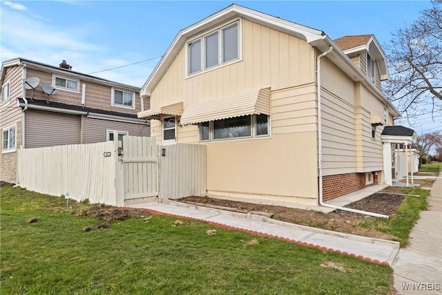 exterior space featuring a yard, fence, and a gate
