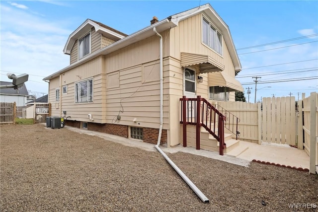 view of property exterior featuring fence and central air condition unit
