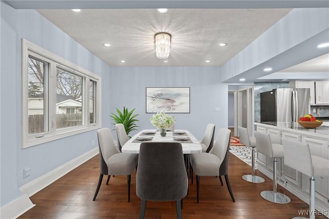 dining area featuring recessed lighting, dark wood-style floors, baseboards, and a textured ceiling