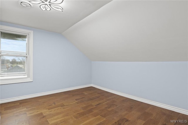 bonus room with wood finished floors, baseboards, and lofted ceiling