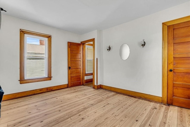 empty room featuring light wood-style floors and baseboards