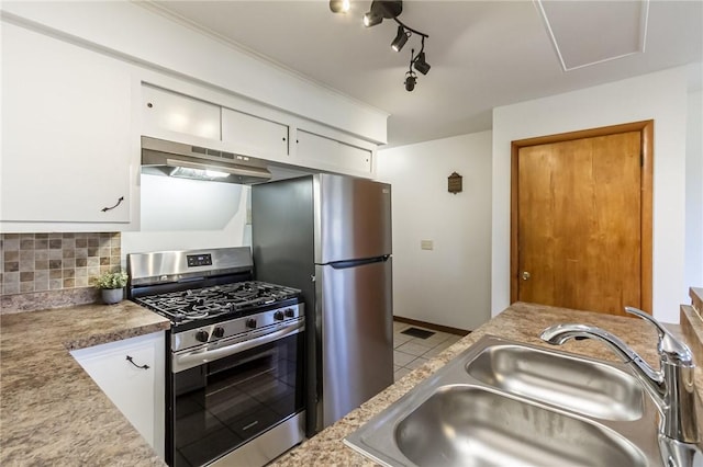 kitchen featuring a sink, appliances with stainless steel finishes, white cabinetry, and under cabinet range hood