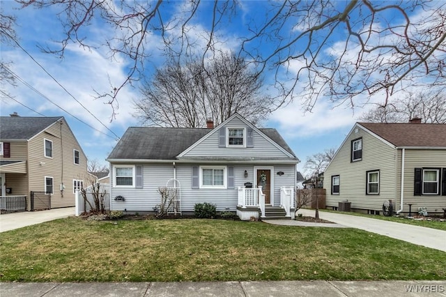 bungalow featuring a front yard, fence, cooling unit, and a chimney