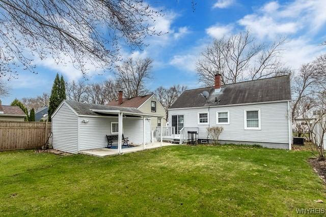 rear view of property with a patio area, fence, and a lawn