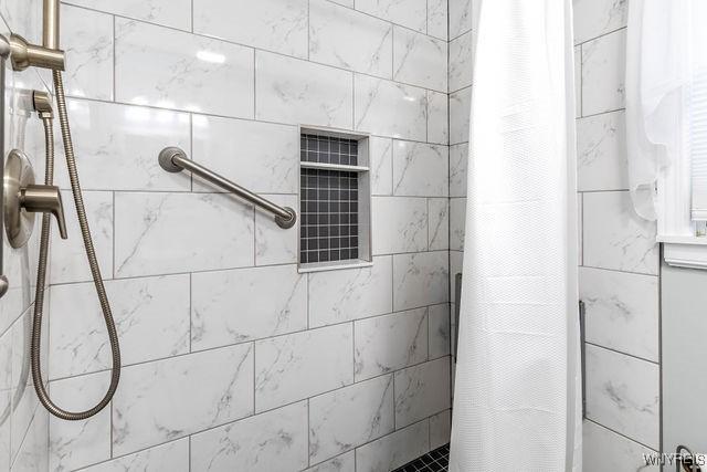 bathroom with a tile shower