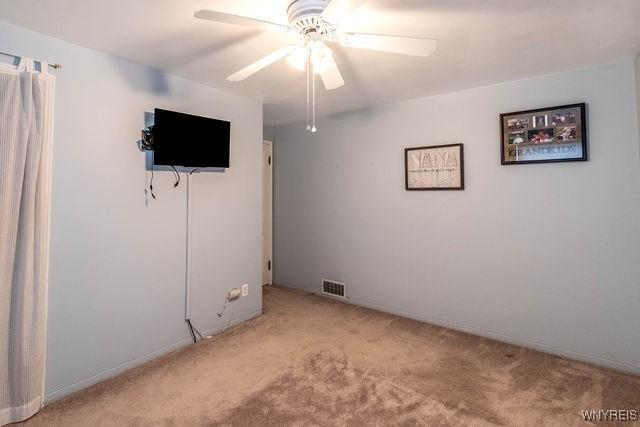 unfurnished bedroom featuring visible vents, ceiling fan, carpet, and baseboards