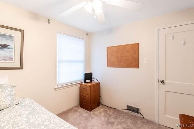 carpeted bedroom with ceiling fan and visible vents