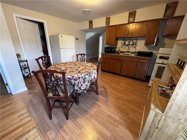 422 N James St, Rome-Inside, NY 13440 - dining area with light wood-style floors, baseboards, and visible vents