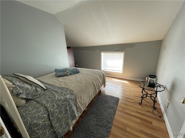 422 N James St, Rome-Inside, NY 13440 - bedroom featuring wood finished floors, baseboards, and vaulted ceiling