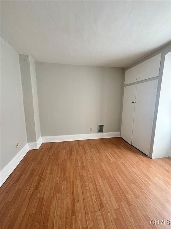 149 River St, Rome-Inside, NY 13440 - unfurnished bedroom featuring light wood-style flooring, a closet, baseboards, and visible vents