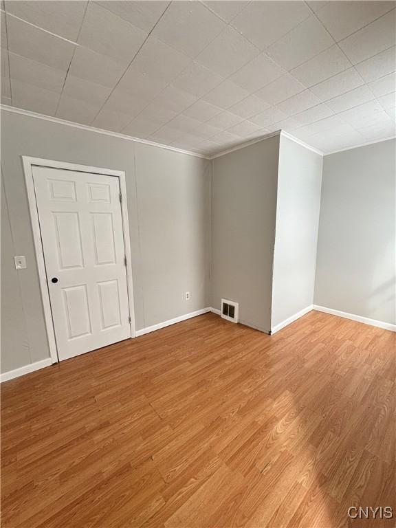 149 River St, Rome-Inside, NY 13440 - spare room with ornamental molding, baseboards, light wood finished floors, and visible vents