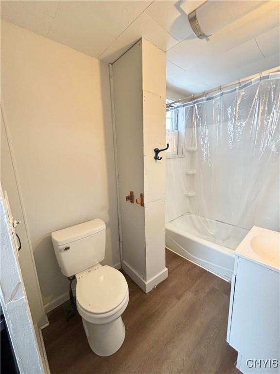 149 River St, Rome-Inside, NY 13440 - full bathroom featuring shower / bath combination with curtain, vanity, toilet, wood finished floors, and baseboards