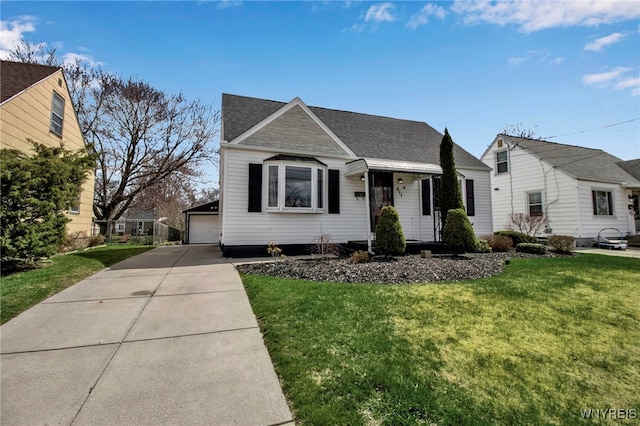 view of front of house with a garage, a front yard, an outdoor structure, and a shingled roof