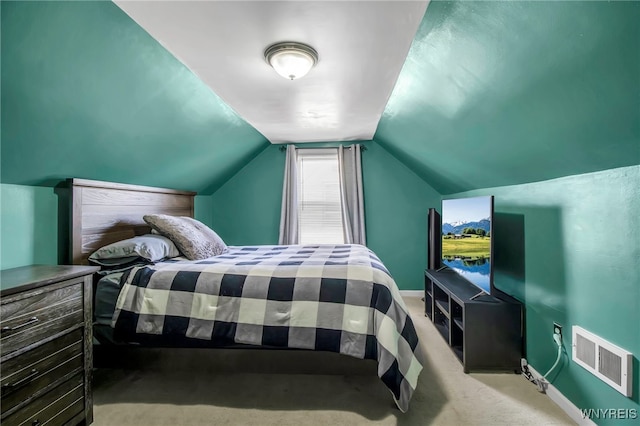 bedroom featuring lofted ceiling, visible vents, baseboards, and carpet floors