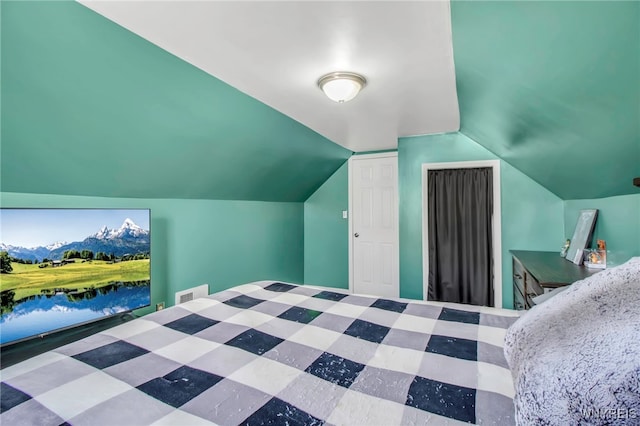 bedroom with visible vents and lofted ceiling