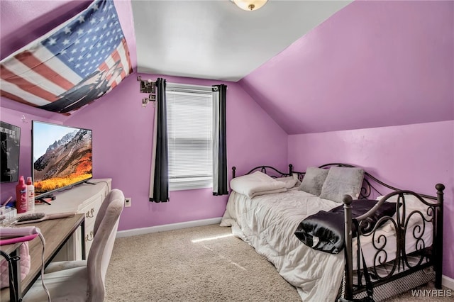 carpeted bedroom featuring baseboards and lofted ceiling