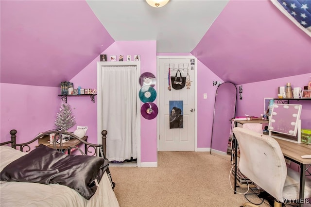carpeted bedroom featuring baseboards and lofted ceiling