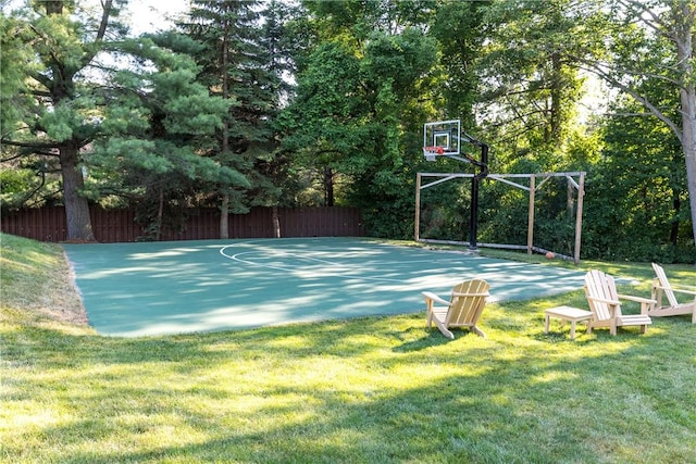5572 Lakewood Trl, South Bristol, NY 14424 - view of sport court featuring fence, basketball hoop, and a lawn