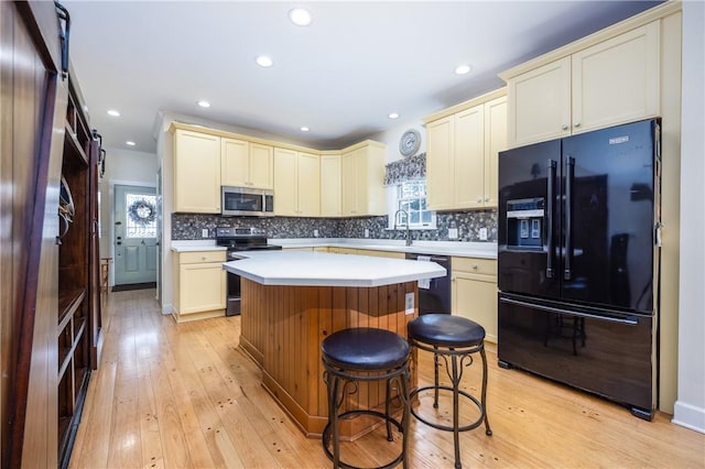 5572 Lakewood Trl, South Bristol, NY 14424 - kitchen featuring a wealth of natural light, cream cabinets, light countertops, and black appliances
