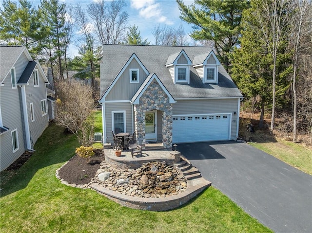 5572 Lakewood Trl, South Bristol, NY 14424 - view of front facade featuring a patio area, a garage, board and batten siding, a front lawn, and driveway