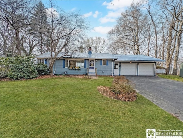 ranch-style home featuring aphalt driveway, metal roof, a front lawn, an attached garage, and a chimney