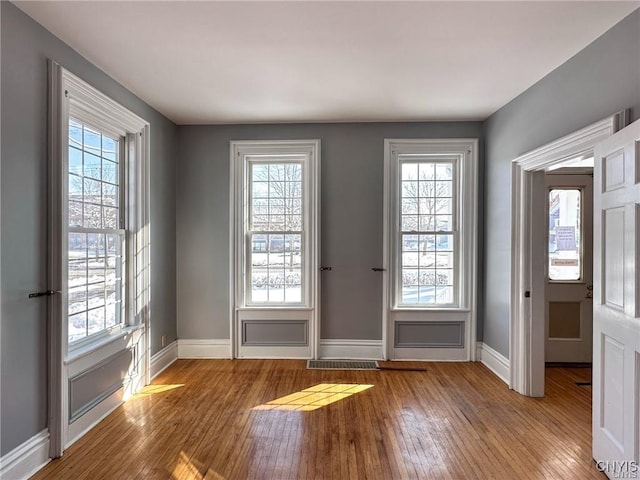 entryway featuring visible vents, wood-type flooring, and baseboards
