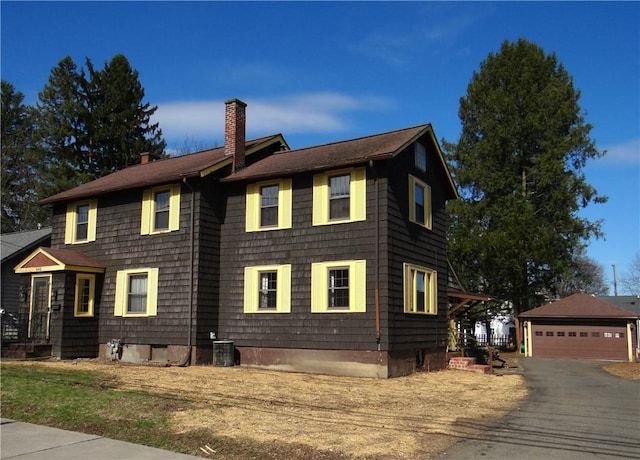 956 Hoffman St, Elmira-City, NY 14905 - view of front of home featuring a garage, central AC, an outdoor structure, and a chimney