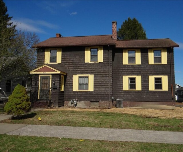 956 Hoffman St, Elmira-City, NY 14905 - colonial house featuring central air condition unit, a chimney, and a front yard