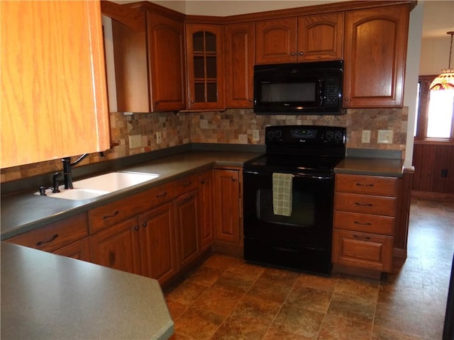 956 Hoffman St, Elmira-City, NY 14905 - kitchen with tasteful backsplash, brown cabinets, a sink, and black appliances
