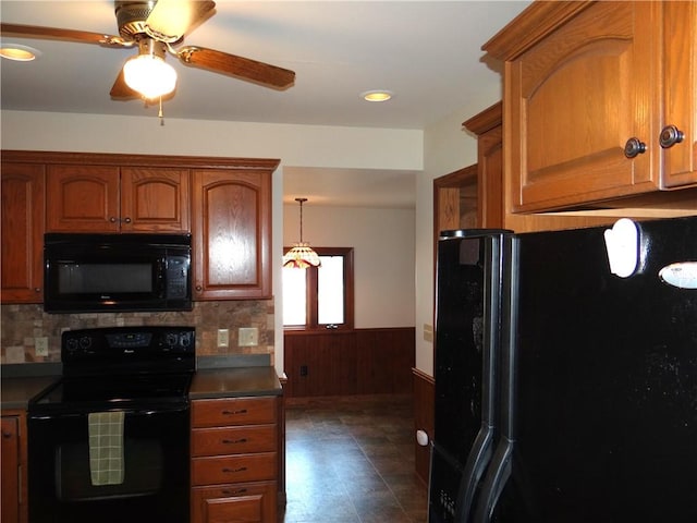 956 Hoffman St, Elmira-City, NY 14905 - kitchen featuring backsplash, a wainscoted wall, black appliances, and a ceiling fan
