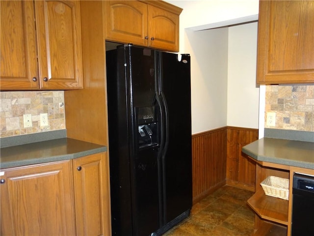 956 Hoffman St, Elmira-City, NY 14905 - kitchen featuring brown cabinetry, black appliances, wood walls, wainscoting, and decorative backsplash