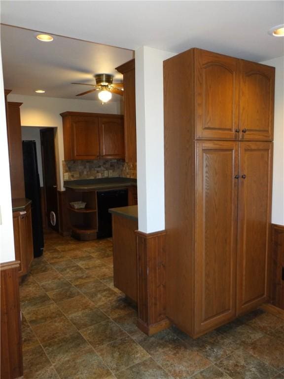 956 Hoffman St, Elmira-City, NY 14905 - kitchen with dishwasher, ceiling fan, dark countertops, brown cabinets, and backsplash