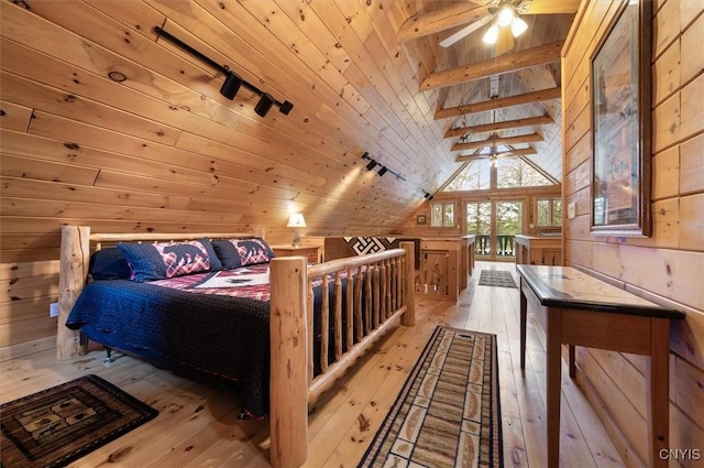 bedroom with wood walls, vaulted ceiling with beams, wooden ceiling, and hardwood / wood-style floors