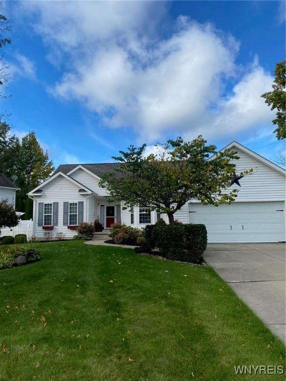 253 Glenvale Rd, Porter, NY 14174 - single story home with concrete driveway, a garage, fence, and a front lawn