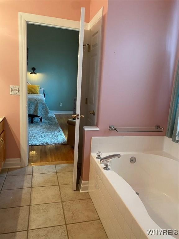 253 Glenvale Rd, Porter, NY 14174 - bathroom with baseboards, vanity, ensuite bath, tile patterned floors, and a garden tub