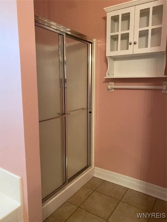 253 Glenvale Rd, Porter, NY 14174 - full bathroom with a shower with shower door, tile patterned flooring, and baseboards