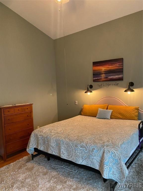 253 Glenvale Rd, Porter, NY 14174 - bedroom featuring vaulted ceiling and wood finished floors