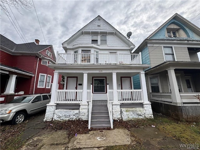 victorian-style house with a balcony and covered porch