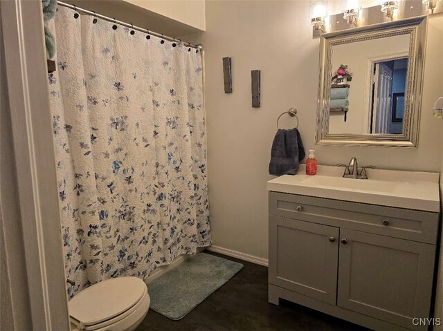 3012 Pleasant Ave, Vienna, NY 13308 - full bathroom featuring curtained shower, vanity, baseboards, and toilet