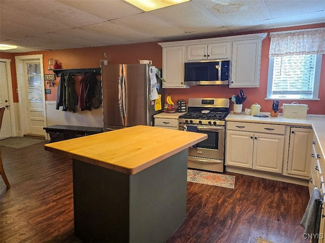 3012 Pleasant Ave, Vienna, NY 13308 - kitchen with dark wood-type flooring, a drop ceiling, white cabinets, appliances with stainless steel finishes, and wooden counters