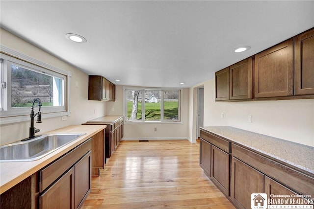 9056 Gross Rd, Cuba, NY 14727 - kitchen featuring light wood finished floors, light countertops, plenty of natural light, and a sink