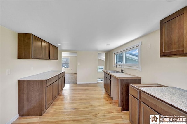 9056 Gross Rd, Cuba, NY 14727 - kitchen featuring light countertops, light wood-type flooring, baseboards, and a sink