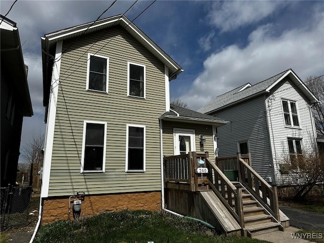 back of property featuring a wooden deck